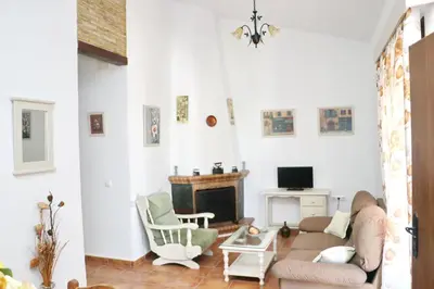 a living room with a couch and a fireplace at Chalet Chaparrillo in Conil de la Frontera