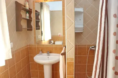 a bathroom with a sink and a mirror at Chalet Chaparrillo in Conil de la Frontera