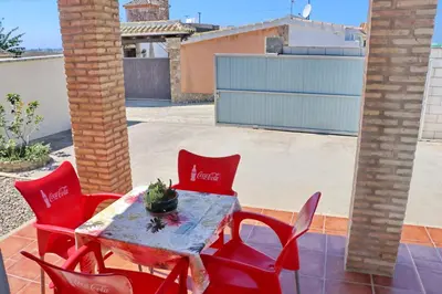 a table and four chairs on a patio at Chalet Chaparrillo in Conil de la Frontera