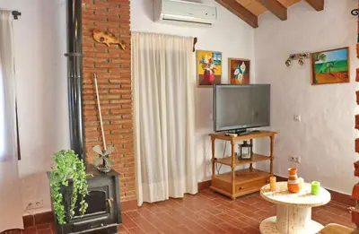 a living room with a fireplace and a television at Apartamento Chinarejo in Conil de la Frontera
