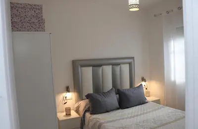 a bedroom with a bed with two pillows on it at Apartamento en Conil con piscina in Conil de la Frontera