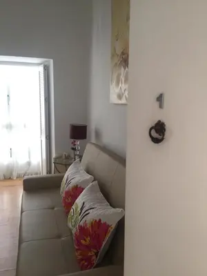 a living room with a couch and a window at La Casa de Abu - Casita con Encanto in Medina Sidonia