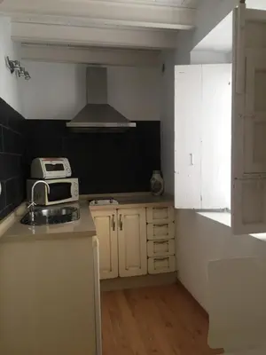 a small kitchen with a sink and a microwave at La Casa de Abu - Casita con Encanto in Medina Sidonia