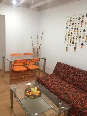 a living room with a couch and a table at La Casa de Abu - Casita con Encanto in Medina Sidonia