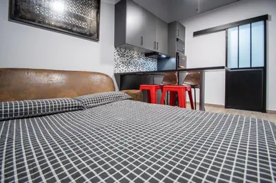 a bedroom with a bed and a kitchen at Caleta Beach in Cádiz