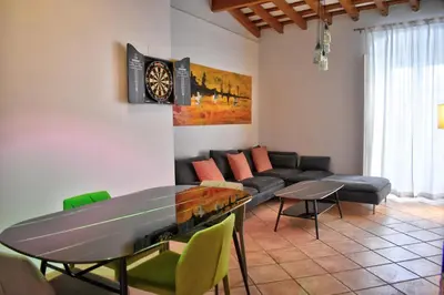 a living room with a table and a couch at Apartamentos Las Naranjas in Jerez de la Frontera