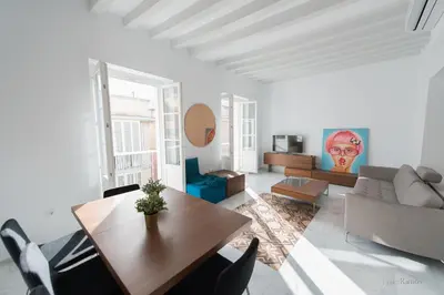 a living room with a table and a couch at Casa Margot Cádiz Grupo AC Gestión in Cádiz