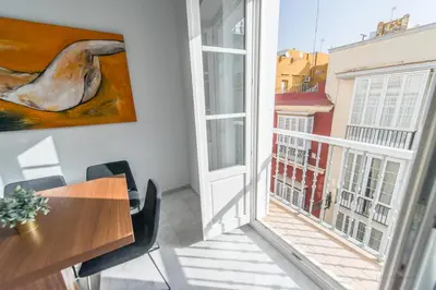 a room with a table and a large window at Casa Margot Cádiz Grupo AC Gestión in Cádiz