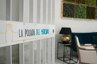 a white gate with a sign in a room at La Posada del Mercado in Cádiz