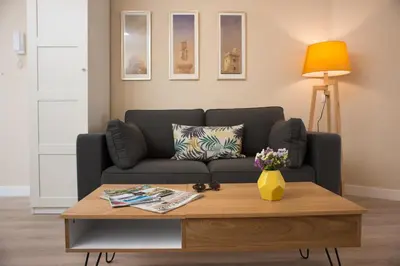 a living room with a couch and a coffee table at La Posada del Mercado in Cádiz