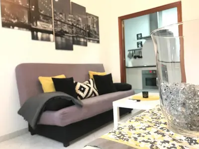 a living room with a purple couch and a table at Apartamento Conocedores in Jerez de la Frontera