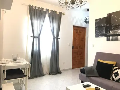 a living room with a couch and a window at Apartamento Conocedores in Jerez de la Frontera