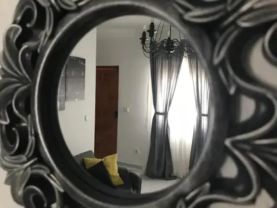 a mirror reflection of a room with a window at Apartamento Conocedores in Jerez de la Frontera