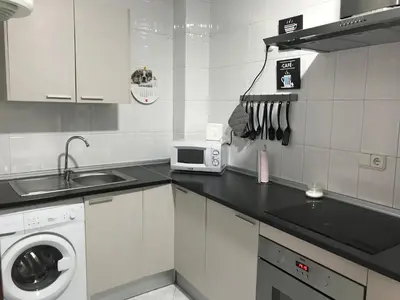 a kitchen with a sink and a washing machine at Apartamento Conocedores in Jerez de la Frontera