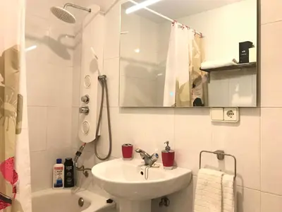 a white bathroom with a sink and a shower at Apartamento Conocedores in Jerez de la Frontera
