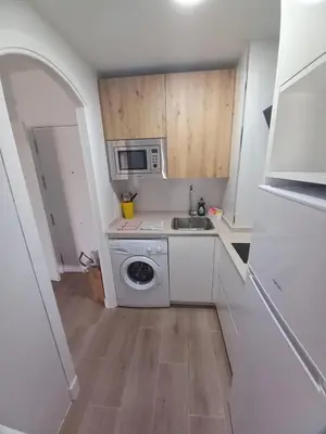 a small kitchen with a sink and a microwave at Apartamento Valdelagrana in El Puerto de Santa María