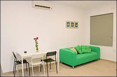a living room with a green couch and a table at Apartamento rural en Conil in Conil de la Frontera