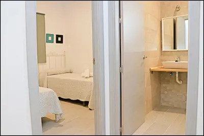 a small bathroom with a sink and a bed at Apartamento rural en Conil in Conil de la Frontera