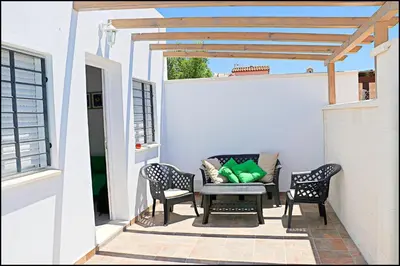 a patio with two chairs and a table and a couch at Apartamento rural en Conil in Conil de la Frontera