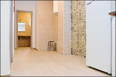 a hallway with a wooden floor and a brick wall at Apartamento rural en Conil in Conil de la Frontera