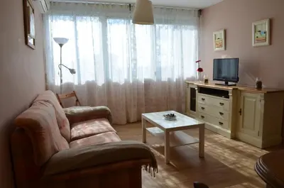 a living room with a couch and a tv at Apartamento Plaza Castañuelas in Jerez de la Frontera