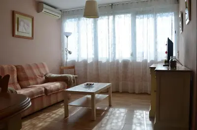 a living room with a couch and a table at Apartamento Plaza Castañuelas in Jerez de la Frontera