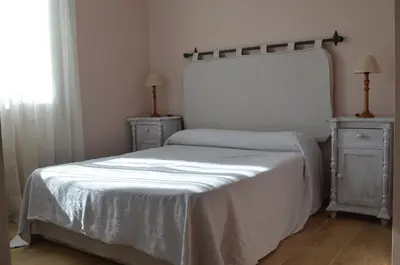 a bedroom with a bed and two dressers and a window at Apartamento Plaza Castañuelas in Jerez de la Frontera