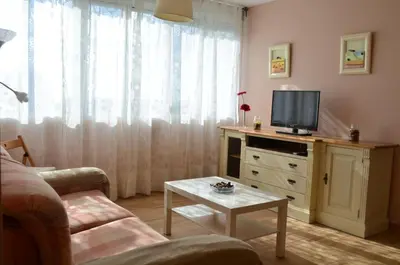 a living room with a couch and a tv on a dresser at Apartamento Plaza Castañuelas in Jerez de la Frontera