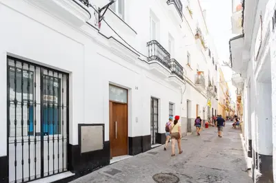 a group of people walking down a street at Casa TANGUILLOS de Cadiz in Cádiz