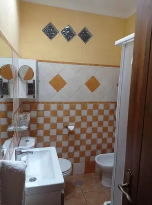 a bathroom with a toilet and a sink at Hostal Costa Luz in El Puerto de Santa María