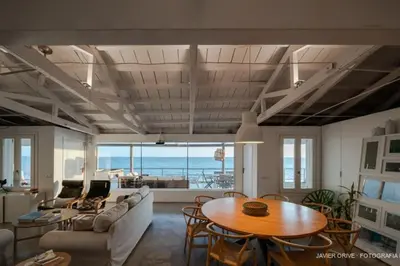 a living room with a table and a couch at La Torre Verde, Villa EN la playa, El Puerto de Santa María in El Puerto de Santa María