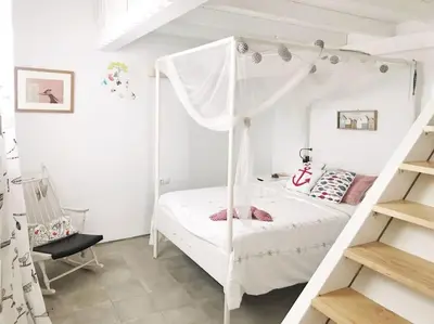 a bedroom with a white bed with a canopy at La Torre Verde, Villa EN la playa, El Puerto de Santa María in El Puerto de Santa María