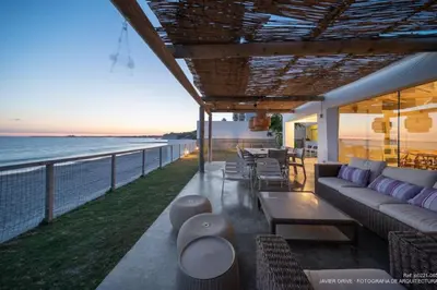 a living room with a couch and a view of the ocean at La Torre Verde, Villa EN la playa, El Puerto de Santa María in El Puerto de Santa María
