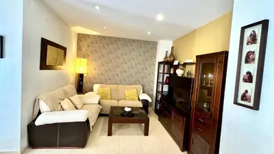 a living room with a couch and a table at SibsSanlucar Reina 2 del Centro Parking in Sanlúcar de Barrameda
