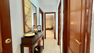 a hallway with a dresser with a mirror and a hallway sidx sidx at SibsSanlucar Reina 2 del Centro Parking in Sanlúcar de Barrameda