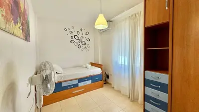 a small room with a bed and a fan at SibsSanlucar Reina 2 del Centro Parking in Sanlúcar de Barrameda
