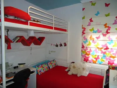a bedroom with a bunk bed and a desk at Apartamento Thebussem in Medina Sidonia