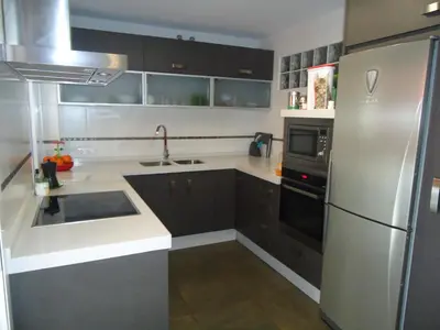 a kitchen with a stainless steel refrigerator and black cabinets at Apartamento Thebussem in Medina Sidonia
