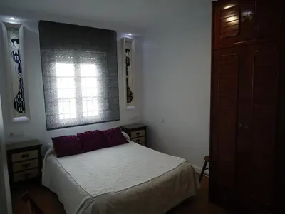 a small bedroom with a bed and a window at Apartamento Thebussem in Medina Sidonia