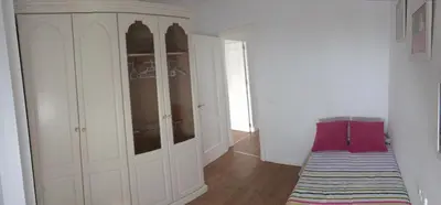 a room with a large white cabinet and a rug at Apartamento Thebussem in Medina Sidonia