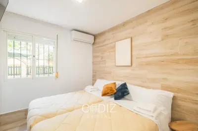 a bedroom with a bed and a painting on the wall at Hospederia IMAR by Cadiz4Rentals in Cádiz