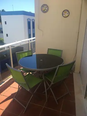 a black table and chairs on a balcony at Atico Costa Ballena golf y playa parking&wifi in Costa Ballena