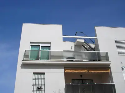 a white building with a balcony on it at Atico Costa Ballena golf y playa parking&wifi in Costa Ballena