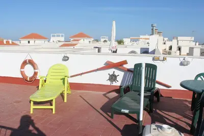 three chairs sitting on top of a roof at Atico Costa Ballena golf y playa parking&wifi in Costa Ballena