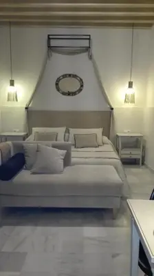 a bedroom with two beds and a mirror on the wall at Estudio Bizcocheros in Jerez de la Frontera