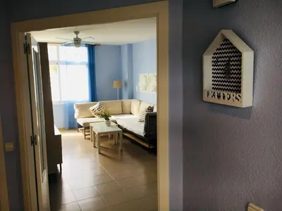 a living room with a couch and a table at Apartamento Costa Ballena con WIFI in Rota