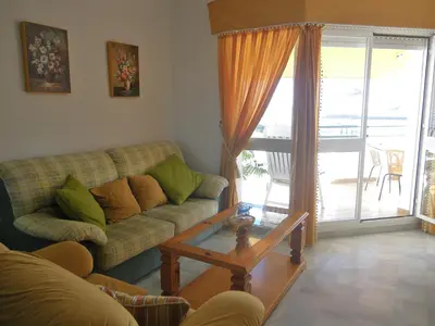 a living room with a couch and a table at Apartamento Pepi Chipiona in Chipiona