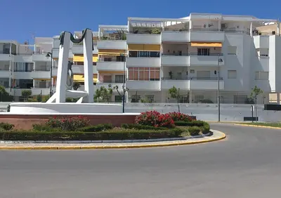 an empty street in front of a large building at Apartamento Pepi Chipiona in Chipiona