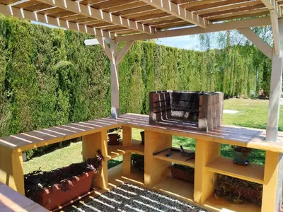 a picnic table with a pergola on a patio at Cabaña Blanca Roche Jorge in Conil de la Frontera