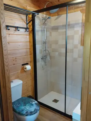 a bathroom with a shower and a toilet at Cabaña Blanca Roche Jorge in Conil de la Frontera